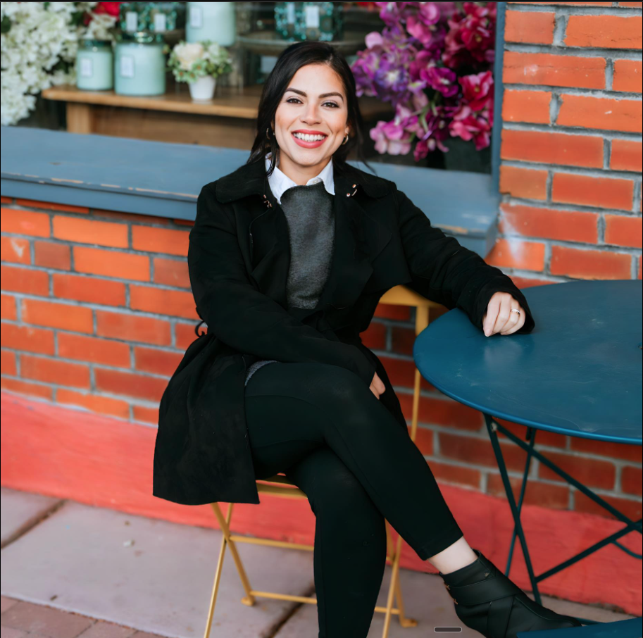 Maddie Cowger, Colorado Realtor, in golden hour light with the Front Range behind her